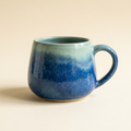 AI-generated concept of an ocean blue ceramic mug with a seafoam rim
